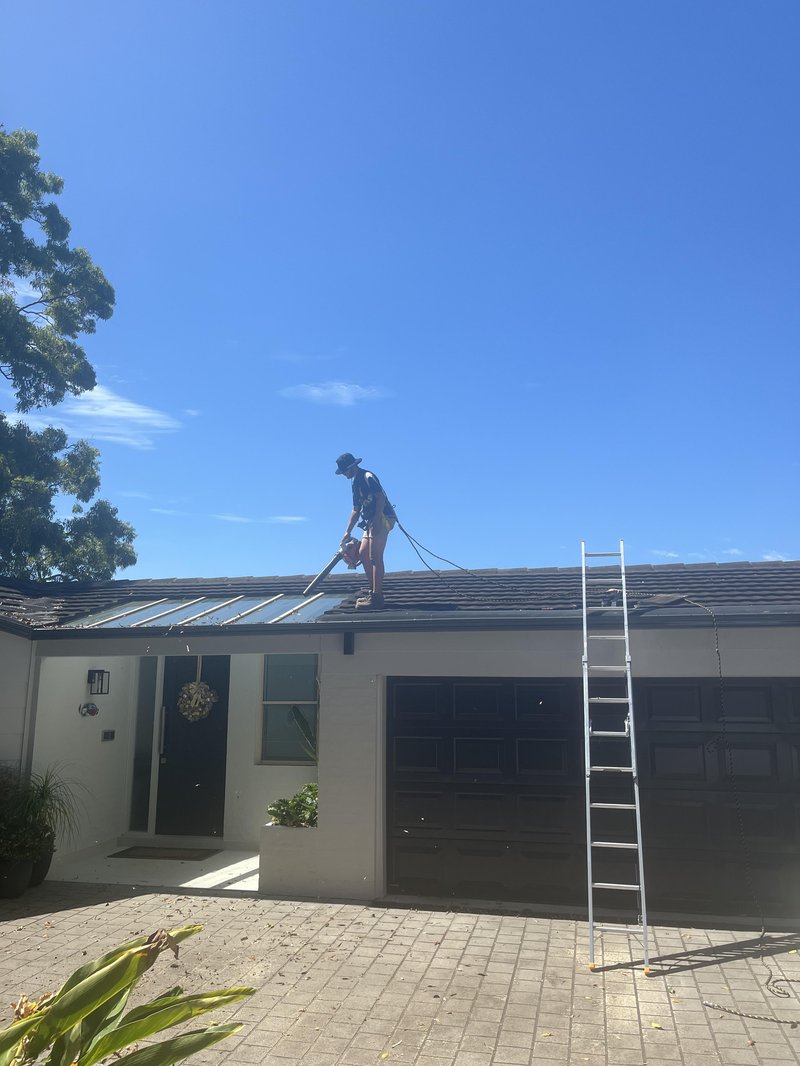 Adin from A&J Exterior working on a roof